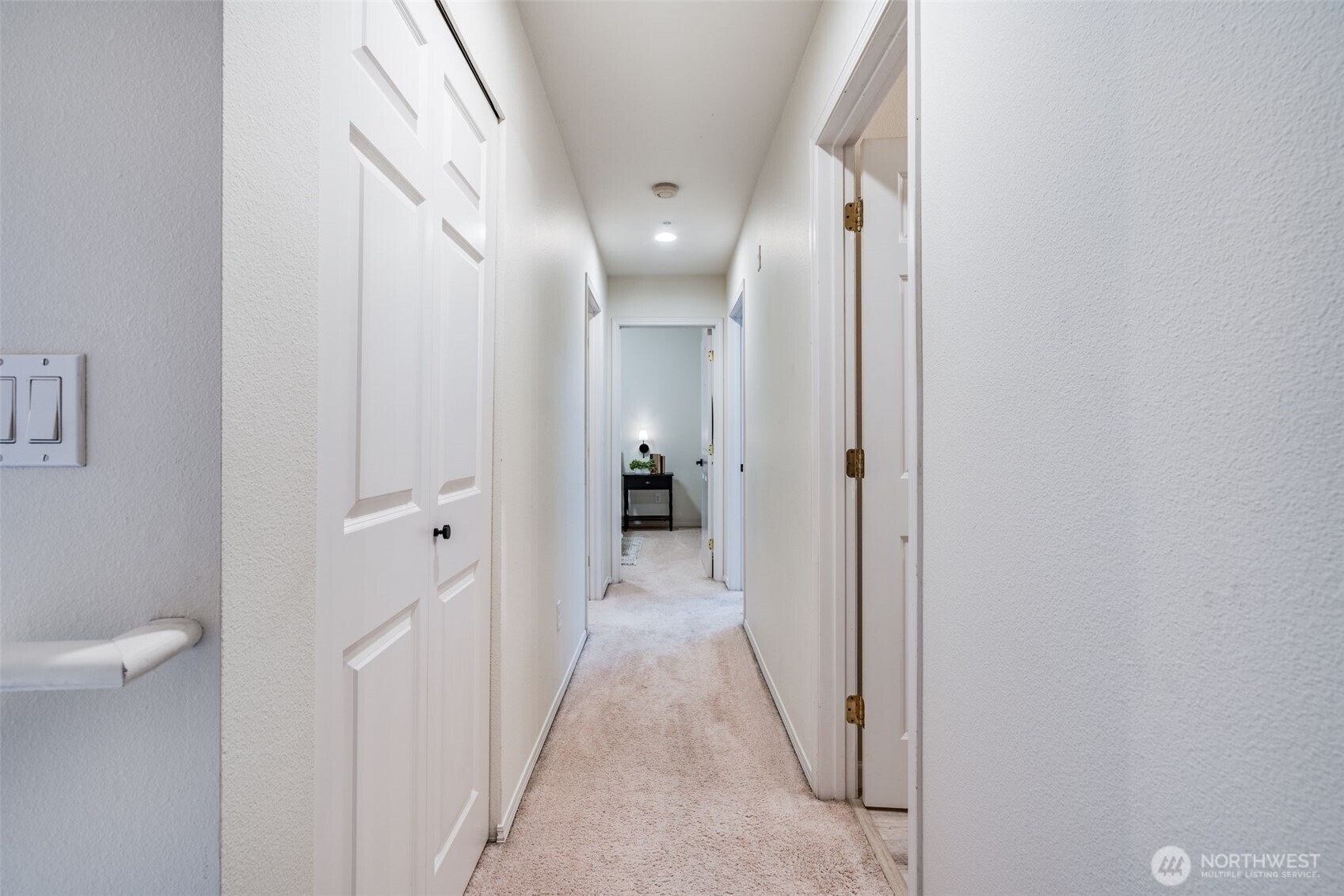 14503 Simonds Road Northeast, Unit C Kirkland, WA 98034 - Photo 17 of 29 a view of a hallway with wooden floor and a bathroom