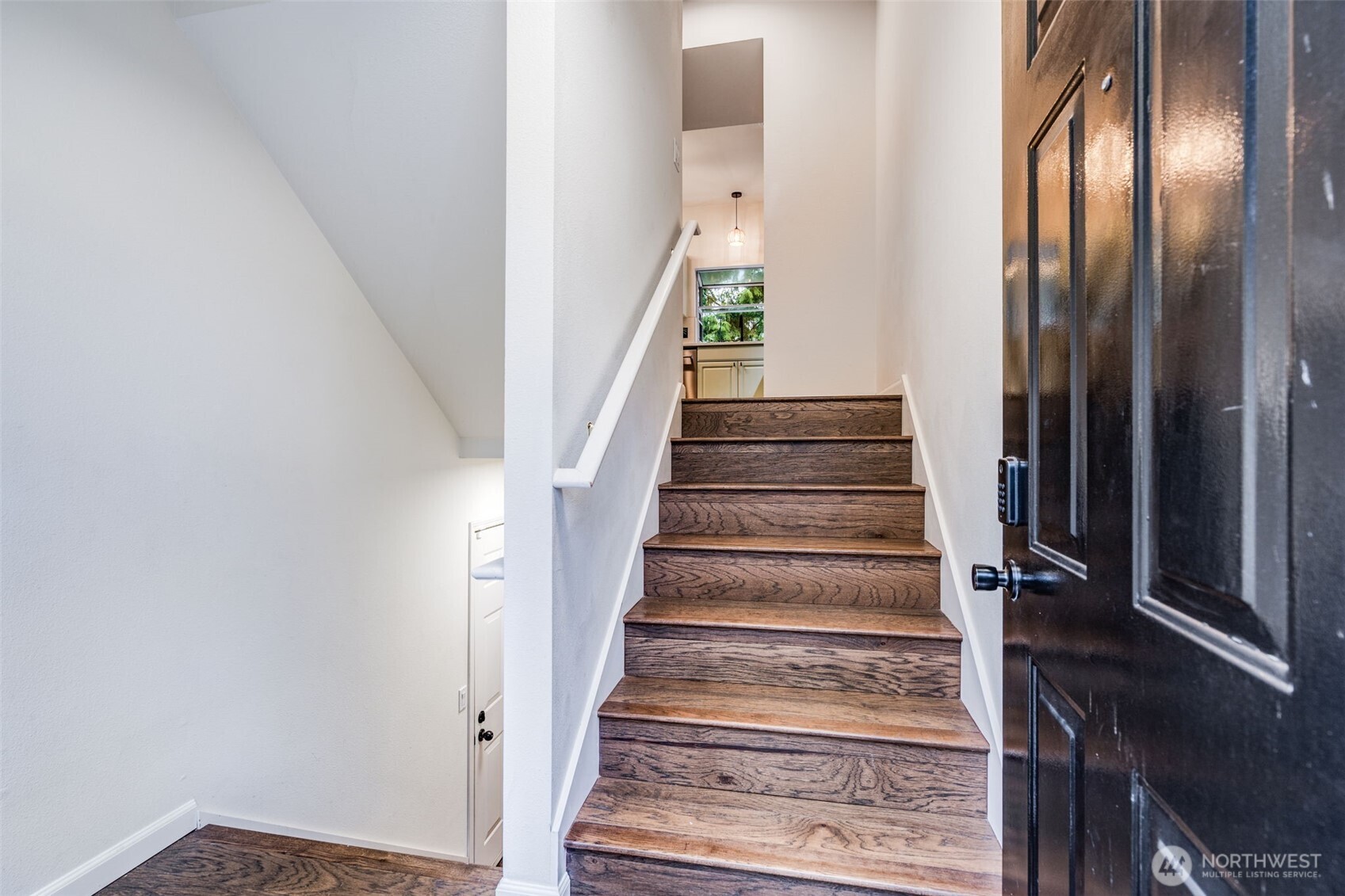 14503 Simonds Road Northeast, Unit C Kirkland, WA 98034 - Photo 2 of 29 a view of staircase with lots of frames on wall and a mirror