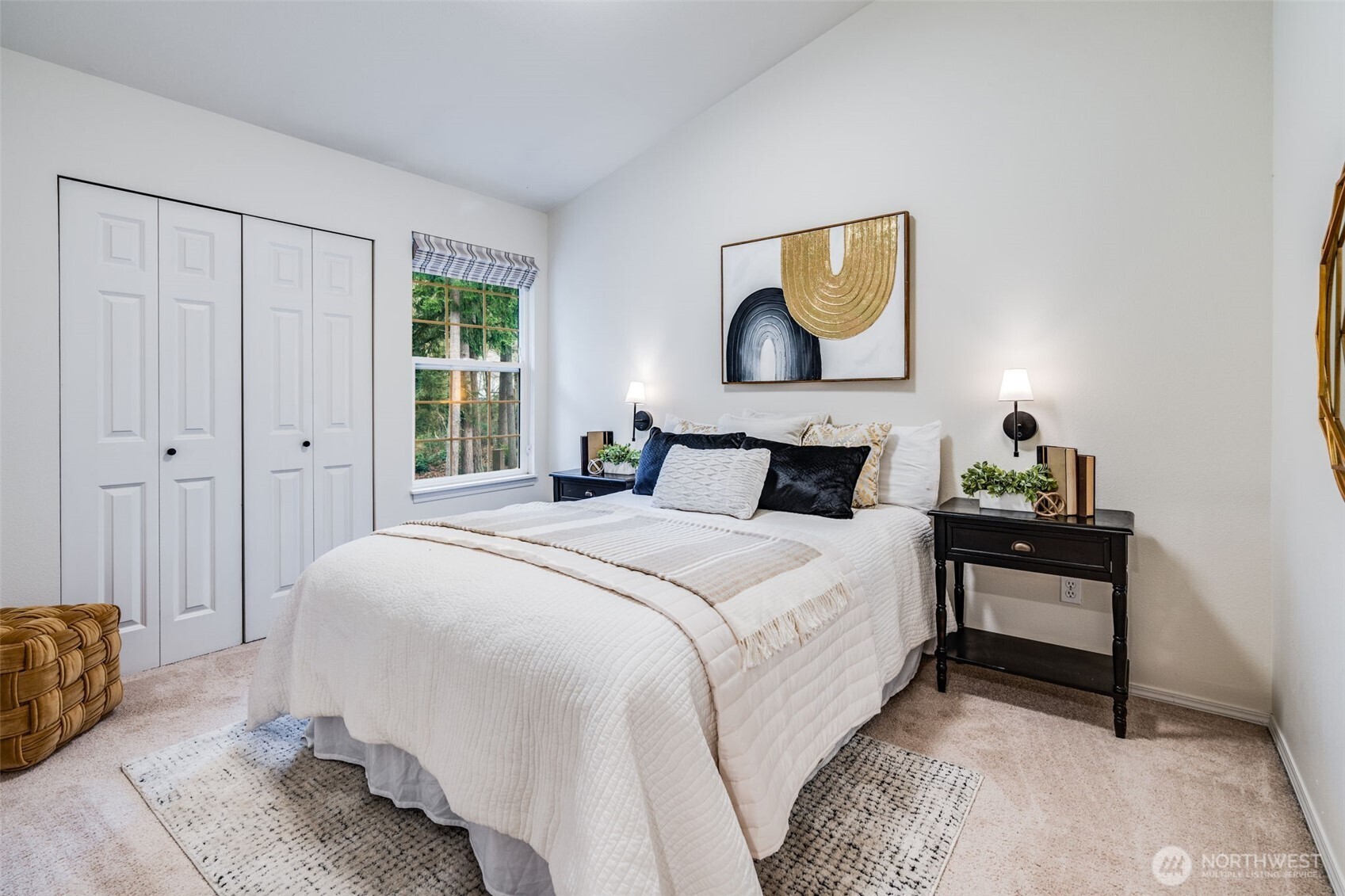 14503 Simonds Road Northeast, Unit C Kirkland, WA 98034 - Photo 24 of 29 a bedroom with a bed and a painting on the wall