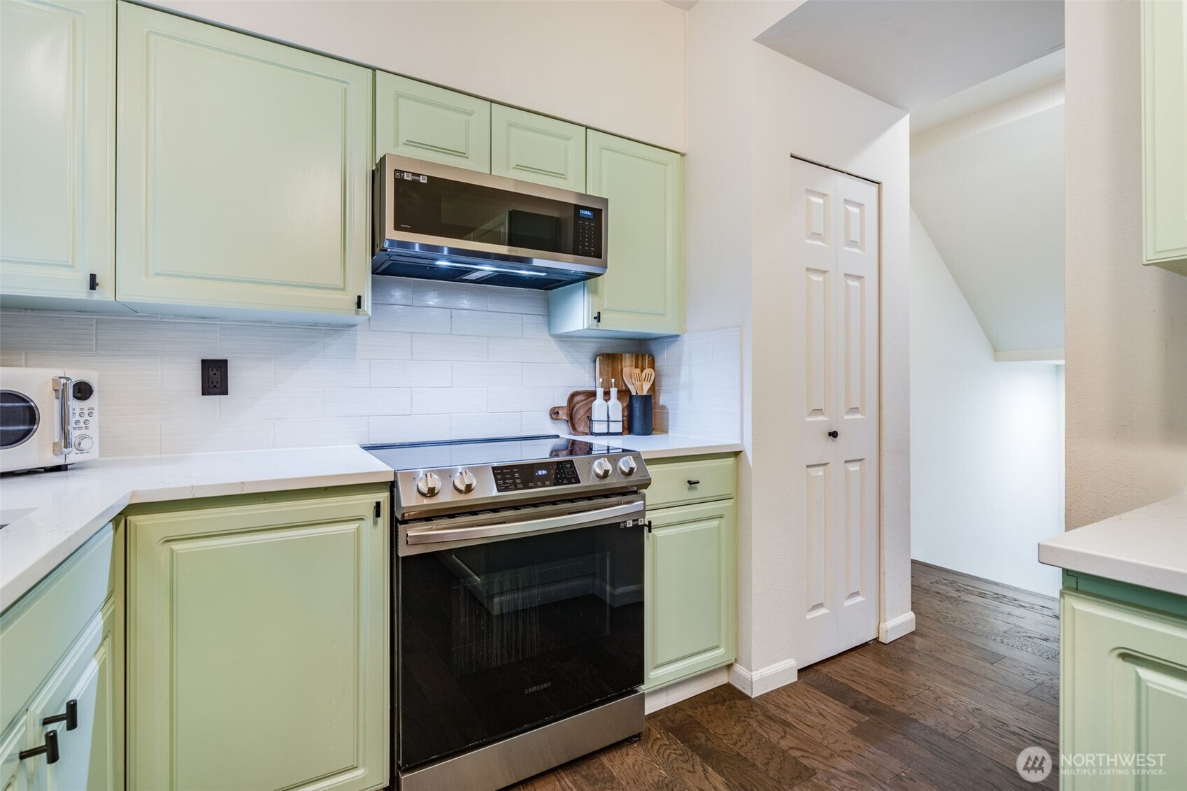 14503 Simonds Road Northeast, Unit C Kirkland, WA 98034 - Photo 10 of 29 a kitchen with stainless steel appliances a stove a microwave and cabinets