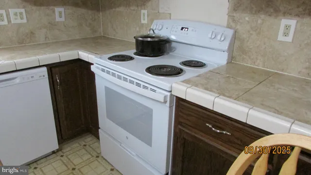 a kitchen with a stove and a refrigerator