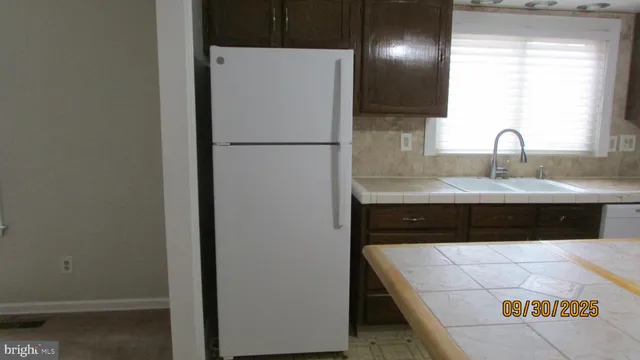 a kitchen with a sink and a refrigerator