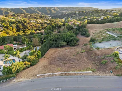 an aerial view of mountains residential house and green space