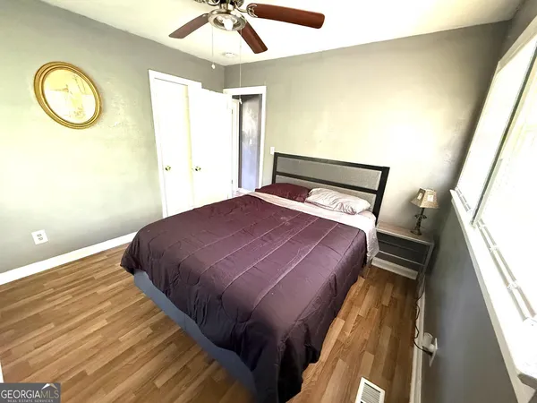 a bedroom with a bed and a window