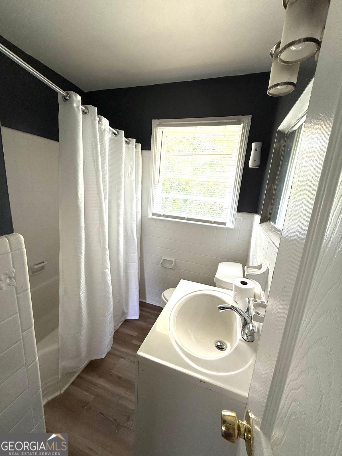 2602 Lake Ridge Circle Rome, GA 30165 - Photo 18 of 19 a bathroom with a sink a mirror a window and a shower