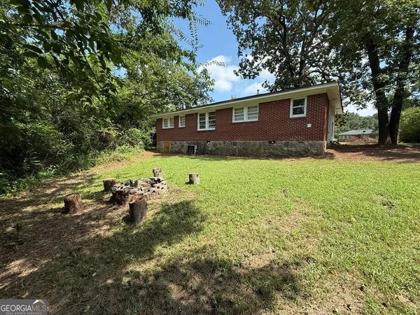 a view of backyard of house with green space