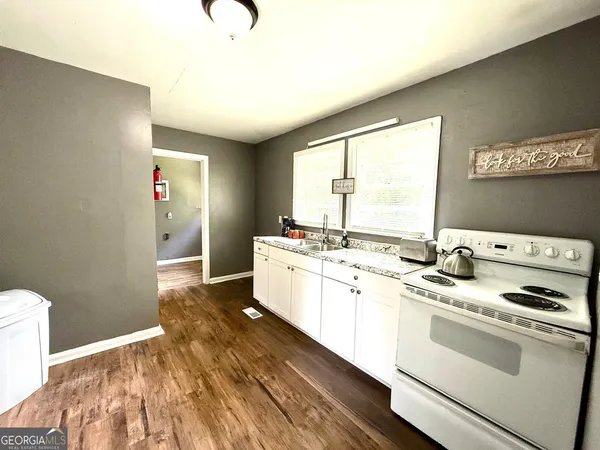 a kitchen with a sink stove and cabinets