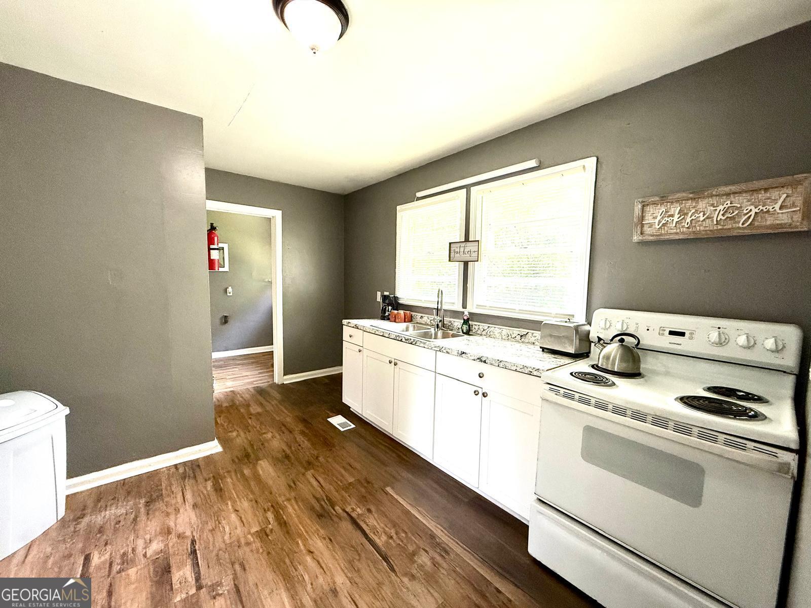 2602 Lake Ridge Circle Rome, GA 30165 - Photo 8 of 19 a kitchen with a sink stove and cabinets