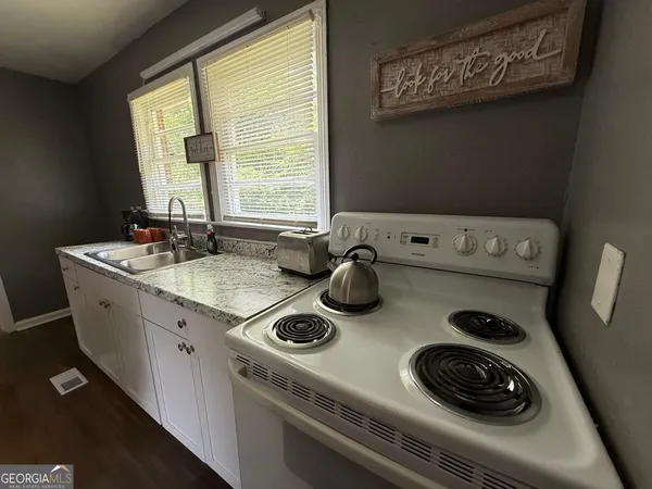 a kitchen with a stove and a sink