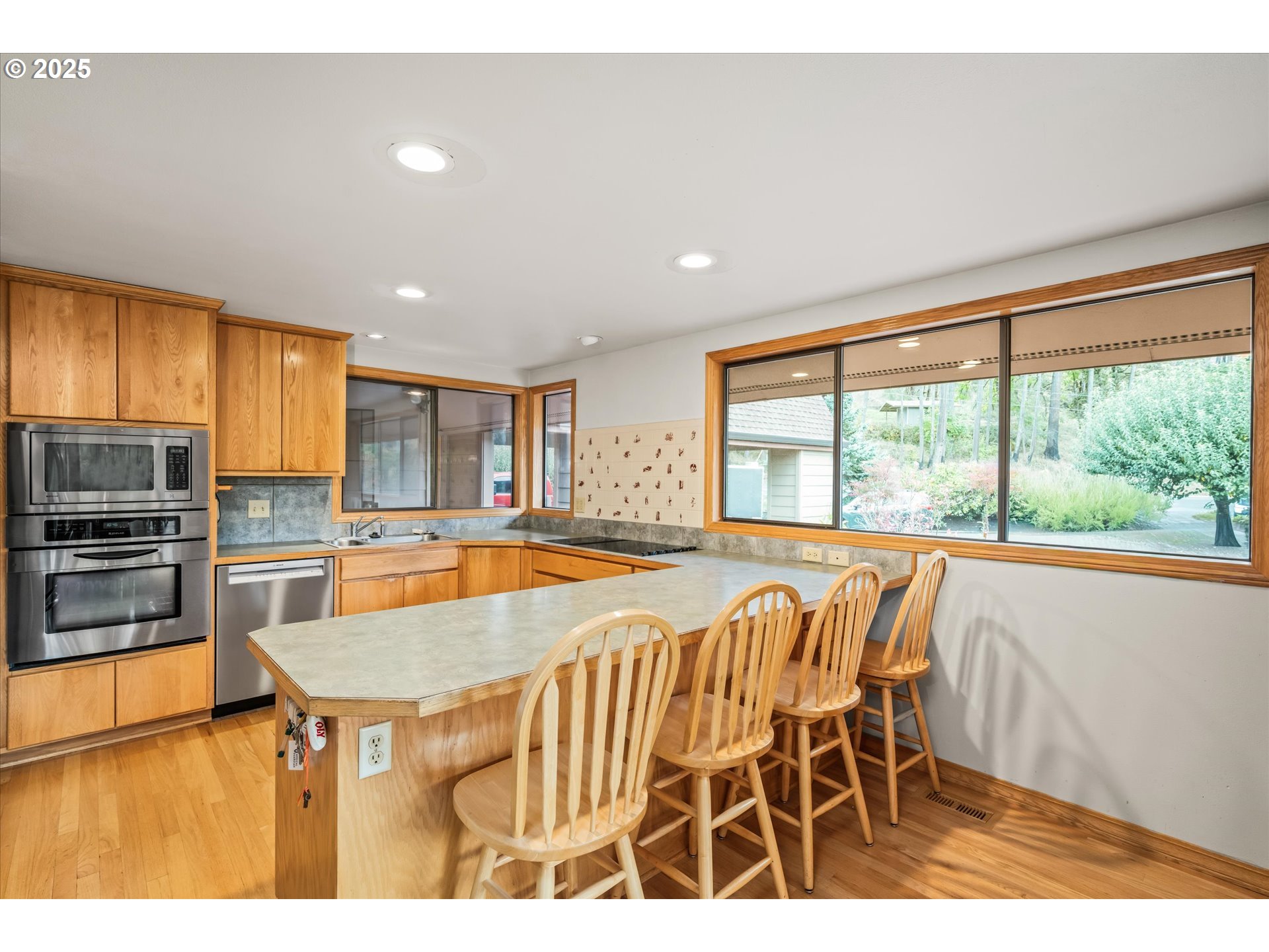 35012 McKenzie View Drive Springfield, OR 97478 - Photo 8 of 47 a view of a kitchen with kitchen island a large window cabinets and stainless steel appliances