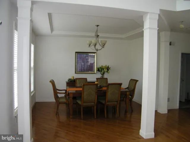 a view of a dining room with furniture and wooden floor