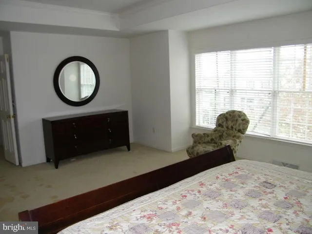 a spacious bathroom with a granite countertop sink and a mirror