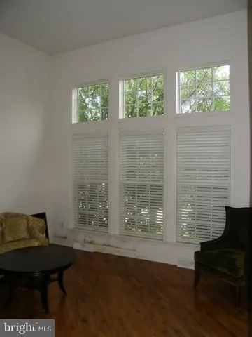 a view of a room with furniture and windows