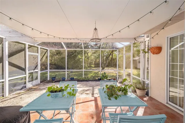 a view of a patio with couches chairs and wooden floor