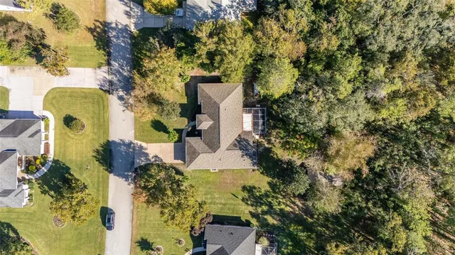 an aerial view of a house with a yard