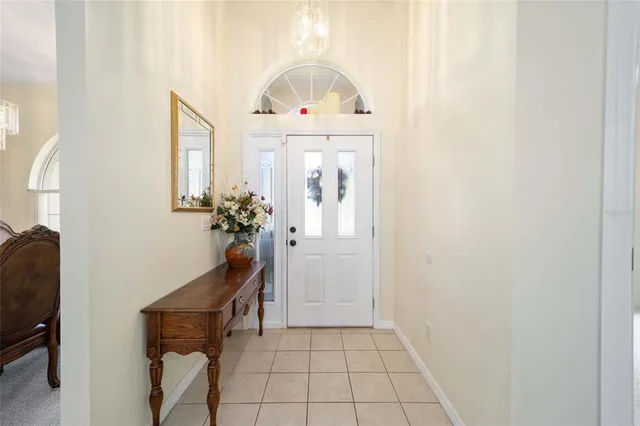 a view of a hallway with furniture and a potted plant