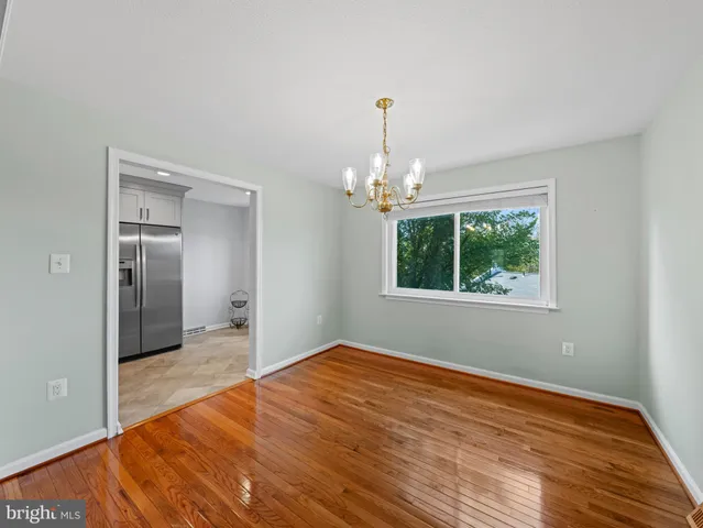 a kitchen with a refrigerator sink and cabinets