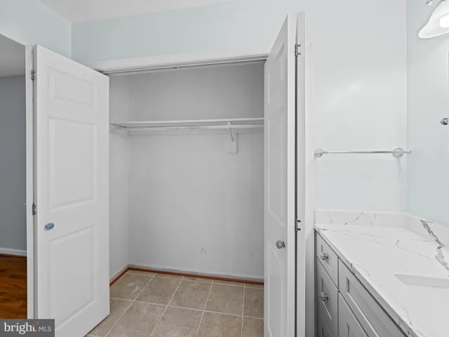 a bathroom with a sink mirror vanity and toilet