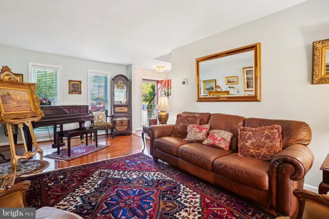a kitchen with stainless steel appliances granite countertop a refrigerator a sink and white cabinets