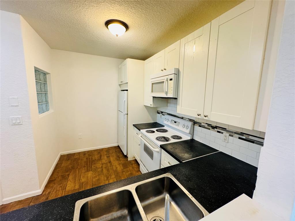 1157 Golden Lakes Boulevard, Unit 622 West Palm Beach, FL 33411 - Photo 11 of 19 a kitchen with a stove and a refrigerator