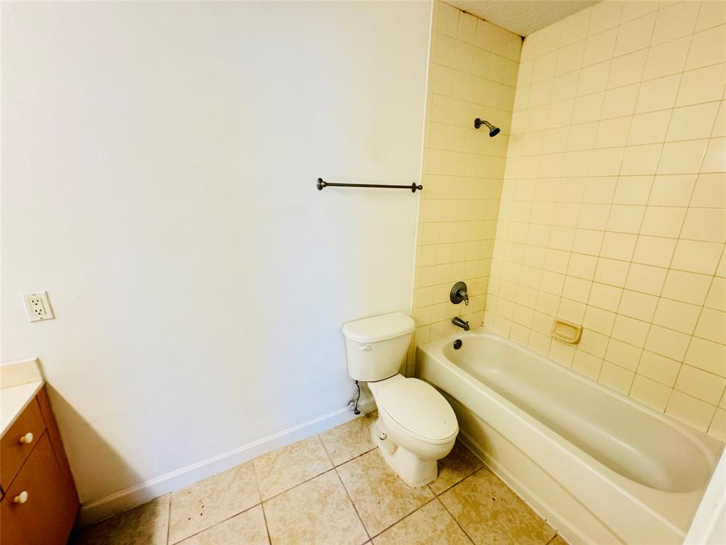 1157 Golden Lakes Boulevard, Unit 622 West Palm Beach, FL 33411 - Photo 9 of 19 a bathroom with a toilet and a shower