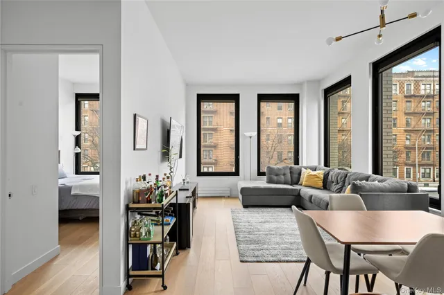 a living room with furniture and floor to ceiling windows