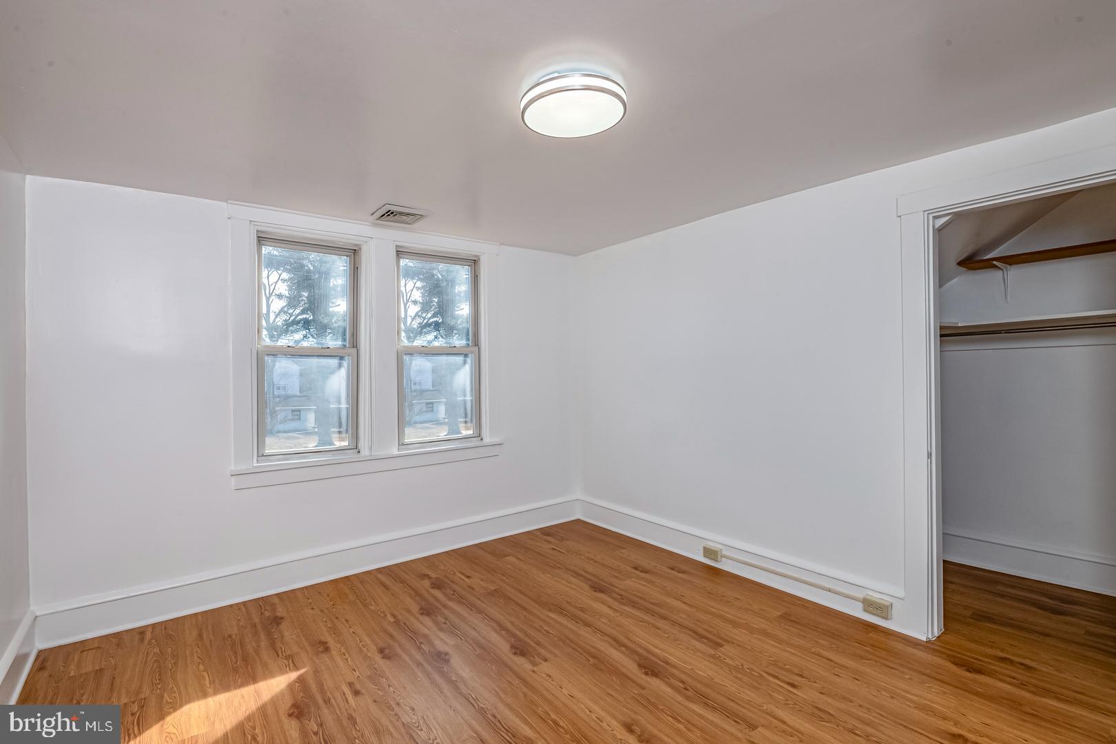 202 Water Street Oley, PA 19547 - Photo 18 of 30 an empty room with wooden floor and windows