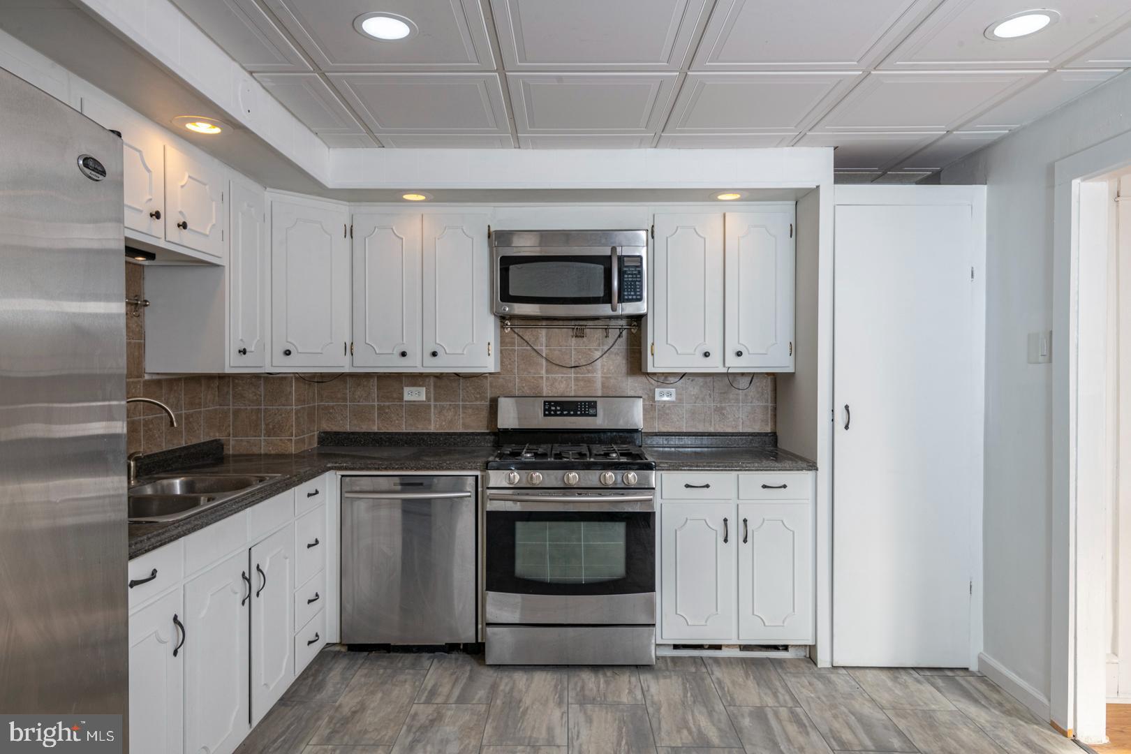 202 Water Street Oley, PA 19547 - Photo 10 of 30 a kitchen with a stove top oven and cabinets