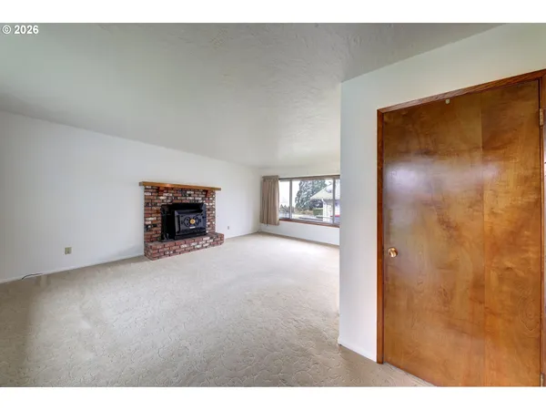a view of an empty room with a fireplace