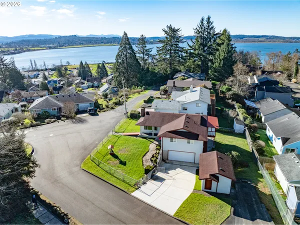 an aerial view of a house with a garden and mountain view in back