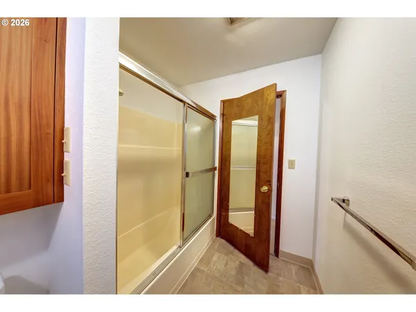 a bathroom with a glass shower door