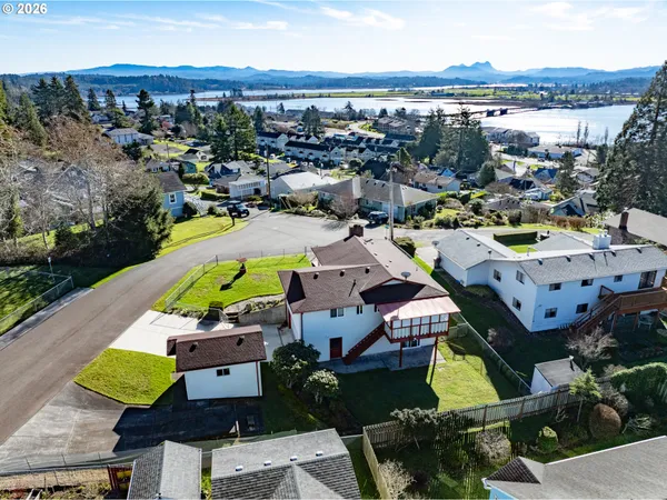 an aerial view of a houses with a swimming pool