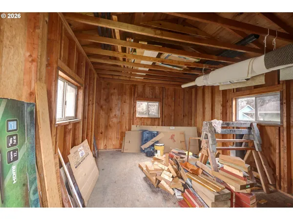 a living room with furniture a wooden floor and next to a window