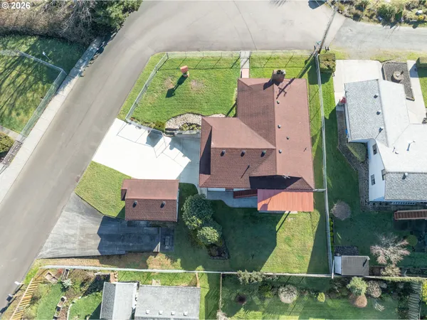 an aerial view of a house with swimming pool and outdoor space