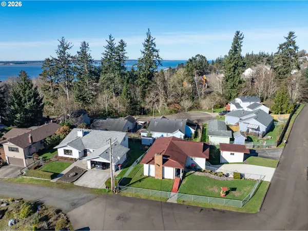 an aerial view of a house with garden space and street view
