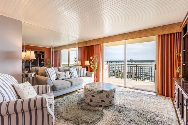 a living room with furniture and a large window with outer view