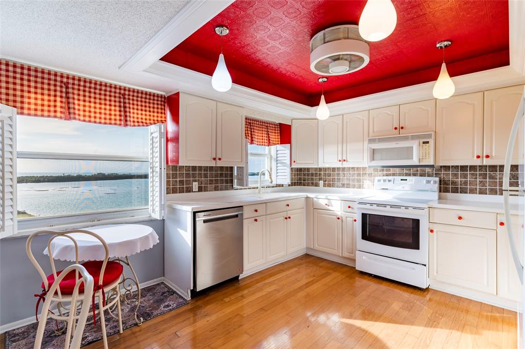 9 Haig Place, Unit 801 Dunedin, FL 34698 - Photo 19 of 36 a kitchen with stainless steel appliances granite countertop a stove cabinets and wooden floor