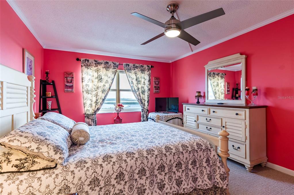 9 Haig Place, Unit 801 Dunedin, FL 34698 - Photo 25 of 36 a bedroom with a large bed and a window