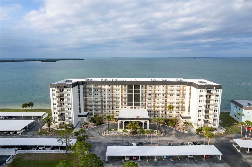 9 Haig Place, Unit 801 Dunedin, FL 34698 - Photo 3 of 36 a front view of a house with a yard