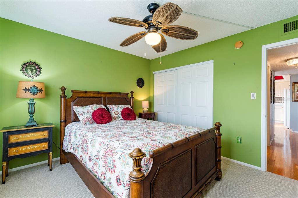 9 Haig Place, Unit 801 Dunedin, FL 34698 - Photo 31 of 36 a bedroom with a bed and a chandelier