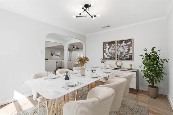 a dining room with furniture potted plants and wooden floor
