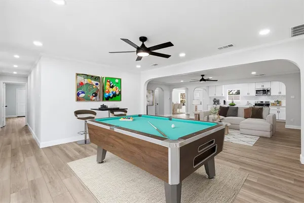 a room with furniture and view of kitchen