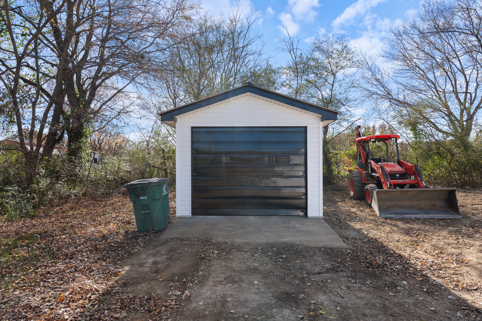 654 West Main Street Hohenwald, TN 38462 - Photo 12 of 33 a view of a house with a yard and garage