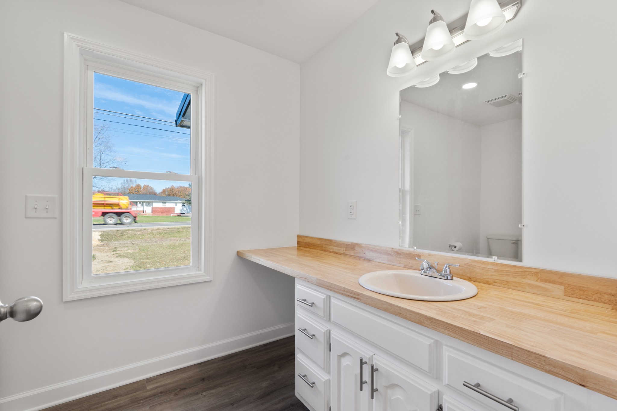 654 West Main Street Hohenwald, TN 38462 - Photo 15 of 33 a bathroom with a sink vanity granite and a mirror