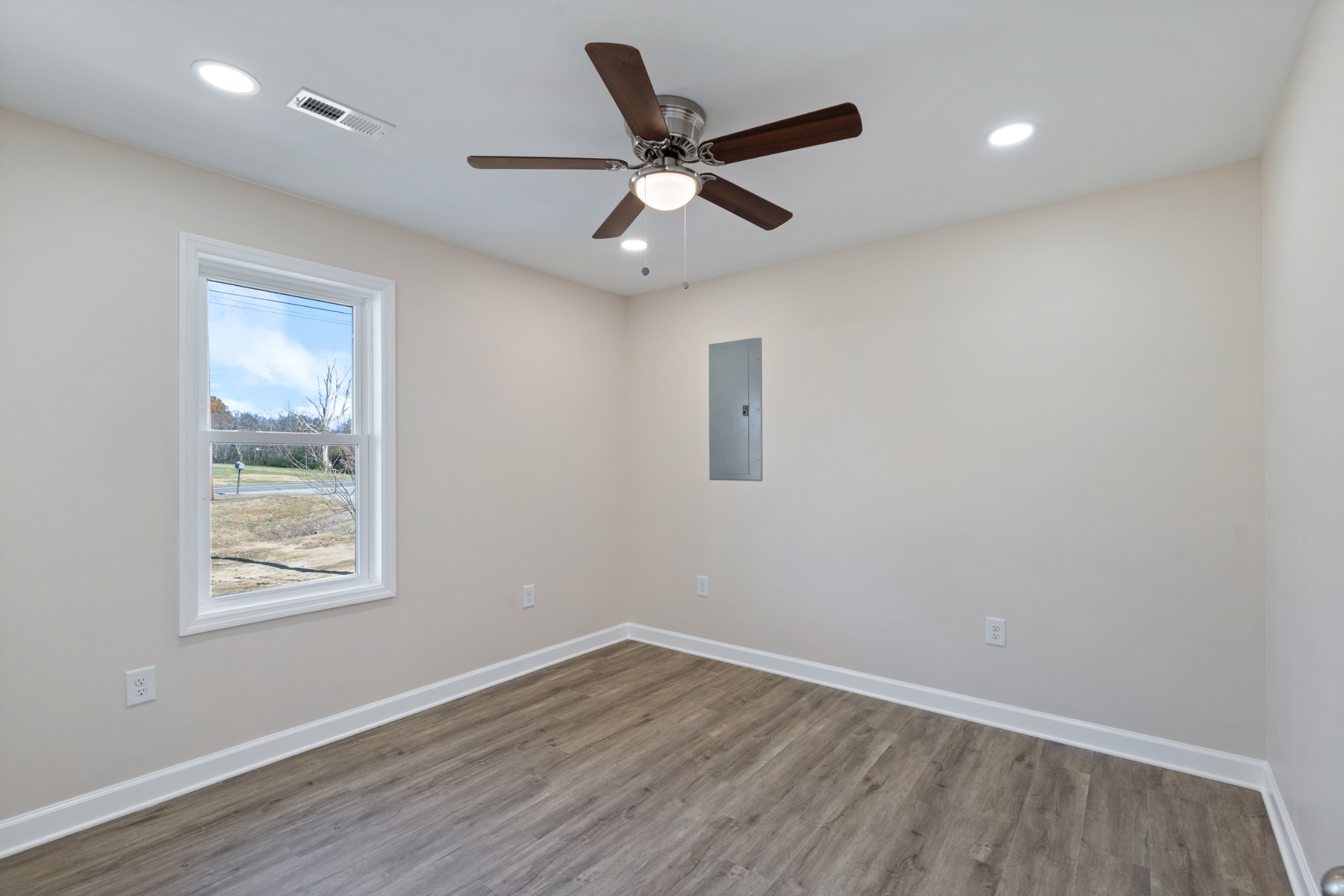 654 West Main Street Hohenwald, TN 38462 - Photo 19 of 33 a view of an empty room with wooden floor and a ceiling fan