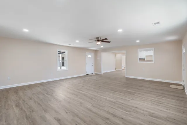 a kitchen with granite countertop a sink stove and cabinets