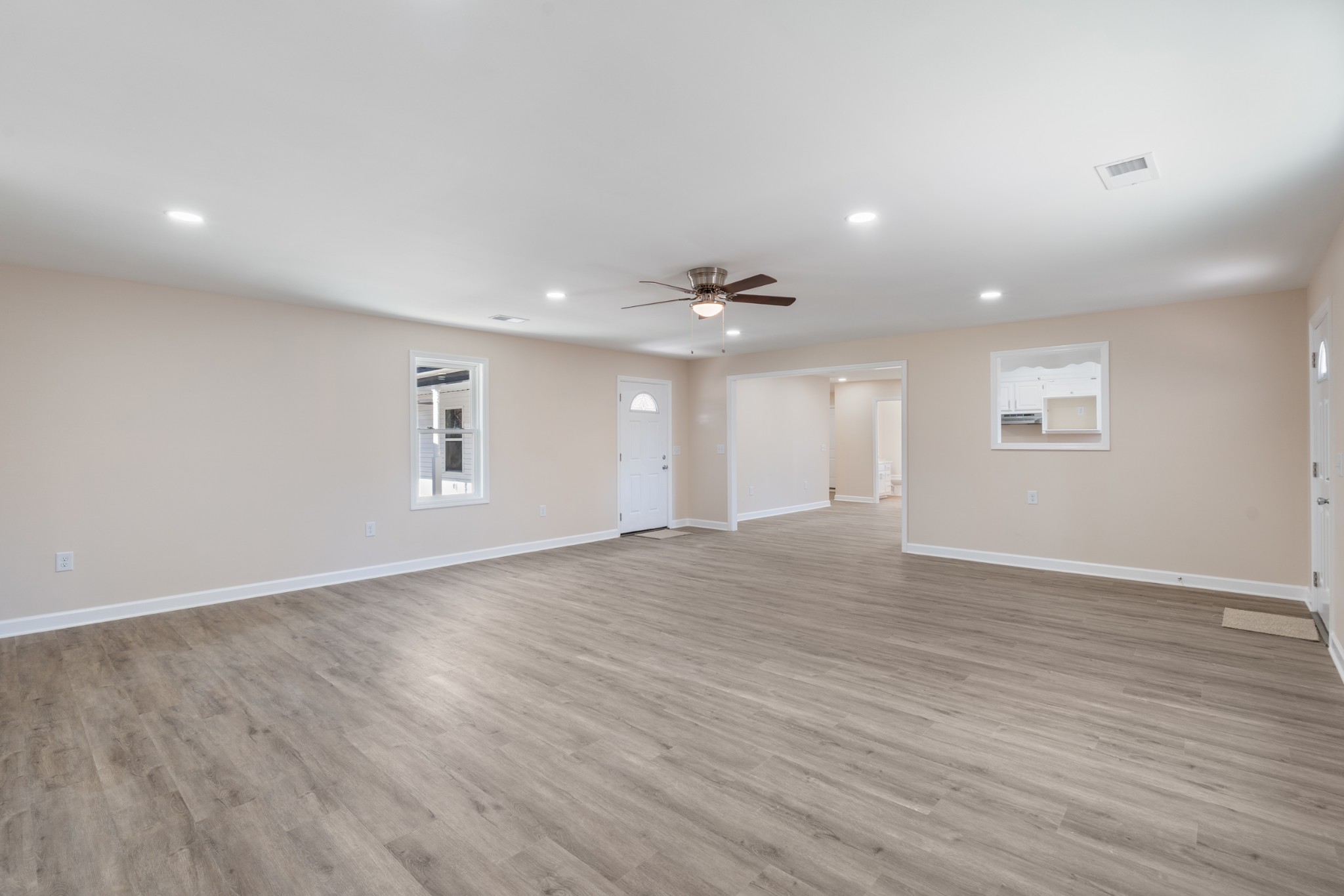 654 West Main Street Hohenwald, TN 38462 - Photo 26 of 33 a view of an empty room with wooden floor and windows