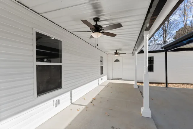 a view of an empty room with wooden floor and fence