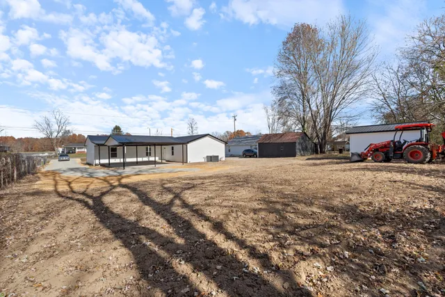 a view of a house with a yard and garage