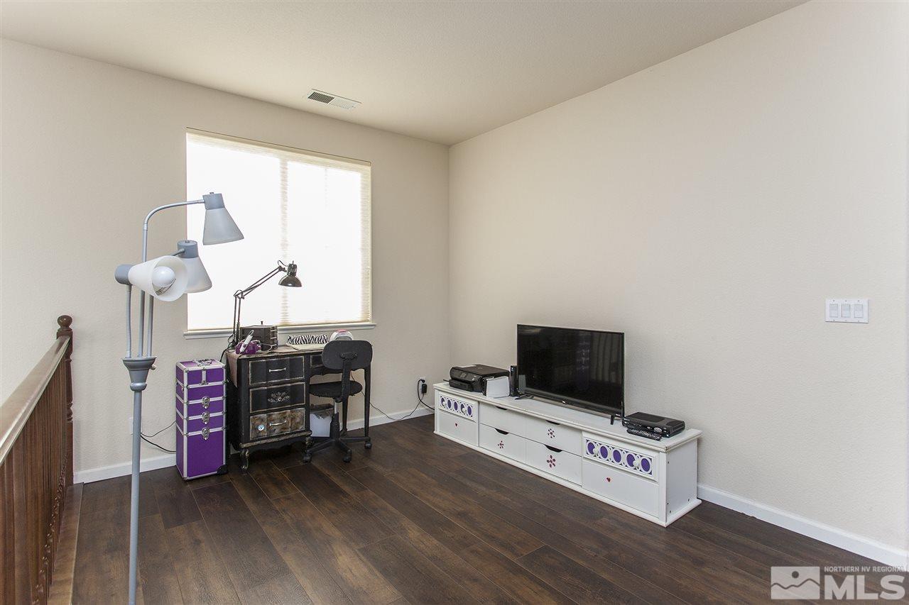 570 Needles Court Reno, NV 89521 - Photo 11 of 18 a living room with furniture and a flat screen tv